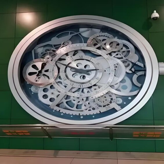 A circular metallic sculpture with interlocking gears and a clock face. 4