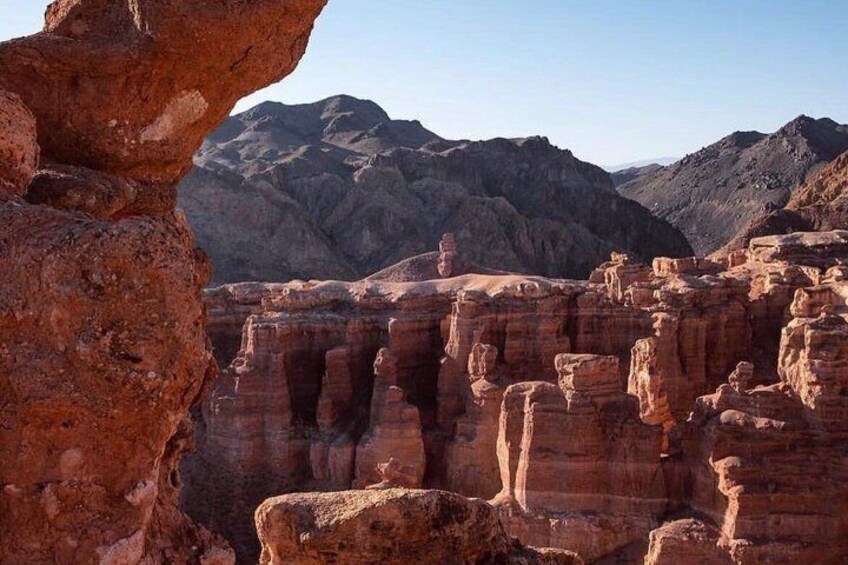 A desert landscape with red rock formations and a clear sky. 3
