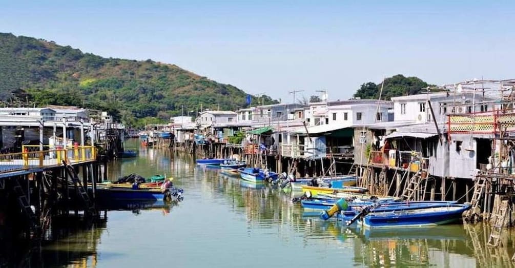 A riverside village with wooden houses and boats. 3