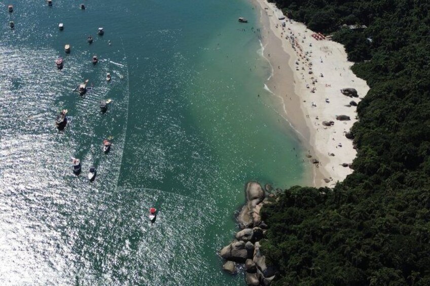 A coastal area with a beach, boats, and rocky outcrops. 2