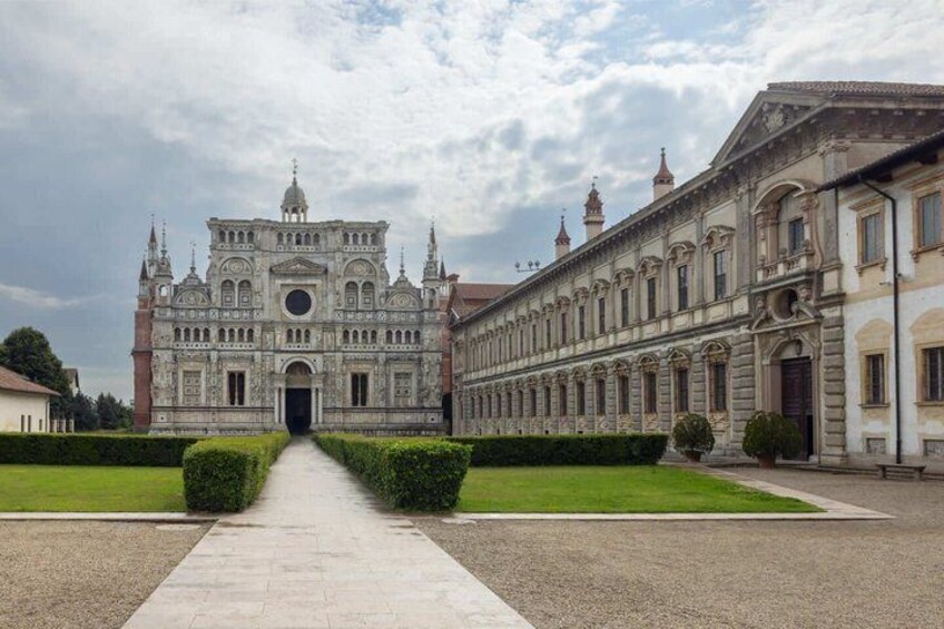 A grand historical building with a symmetrical facade, a central dome, and a long colonnade. 4