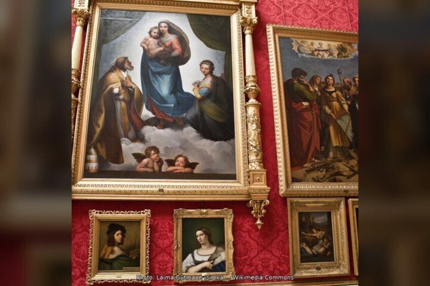 A wall with religious paintings and ornate frames. 4