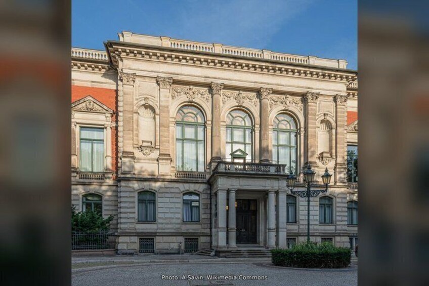 A classical building with arched windows and a central entrance. 2