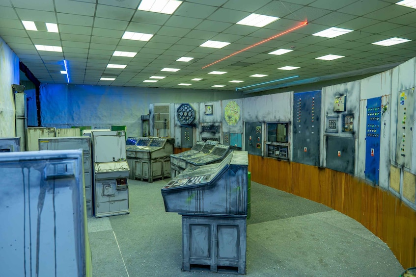 A control room with multiple control panels, switches, and gauges. 2