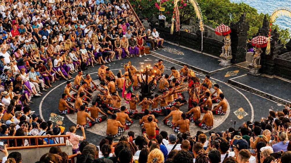 A group of people in traditional attire performing a ritual in a circular formation, surrounded by an audience. 1
