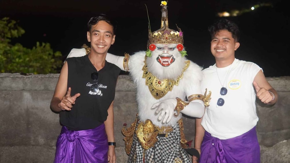 Two people posing with a person in a traditional costume. 2