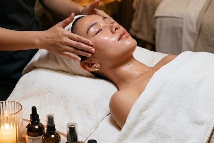 A person receiving a facial treatment with a towel wrapped around their head. 1