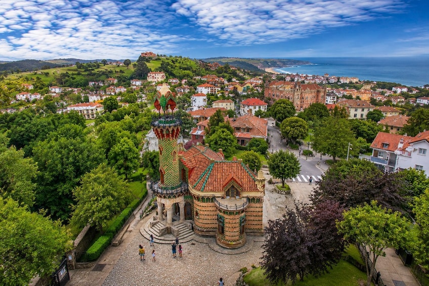 A historic town with a prominent tower and lush greenery. 5