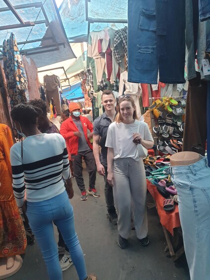 A market with various clothing items and shoes on display. 5
