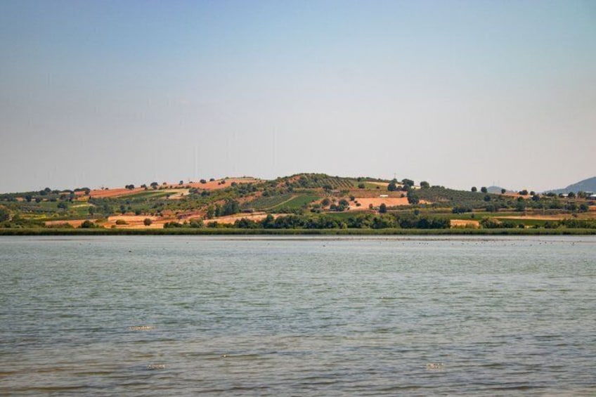 A calm lake with a hilly landscape in the background. 5