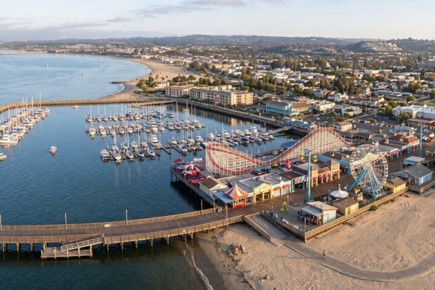 A coastal town with a marina, amusement park, and a large Ferris wheel. 4