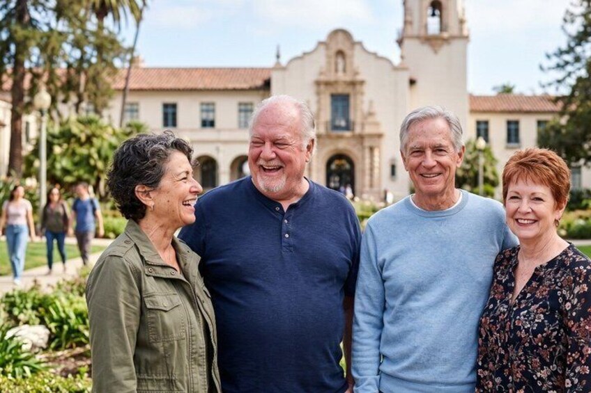 A group of people standing in front of a historic building with a bell tower. 3