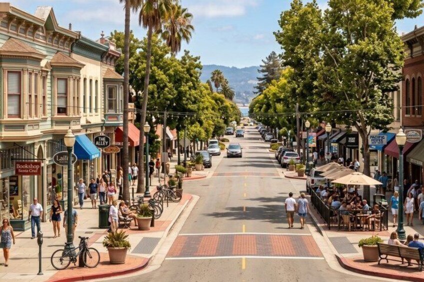 A street lined with shops and cafes, palm trees, and a mountain in the distance. 2