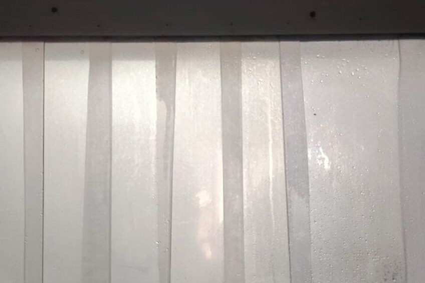 A white surface with vertical lines and a small, indistinct object in the center. 5