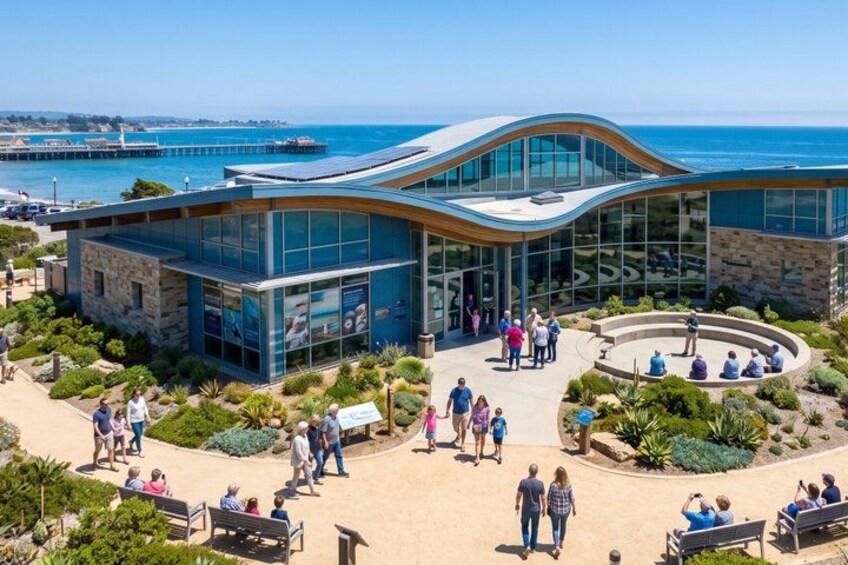 A modern building with a curved glass facade, surrounded by a landscaped garden with benches and pathways. 3