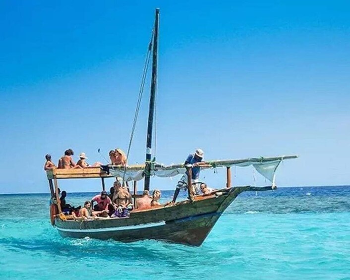 A traditional wooden boat with passengers on a calm sea. 2