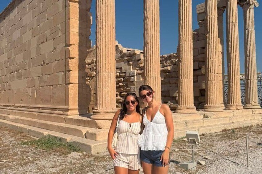 Ancient ruins with columns and a stone structure. 3