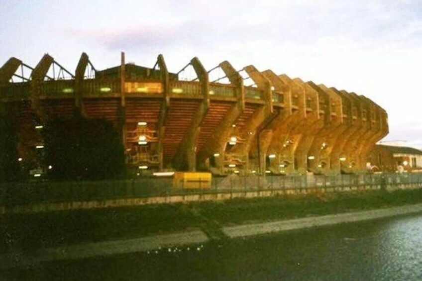 A stadium with a distinctive roof structure. 2