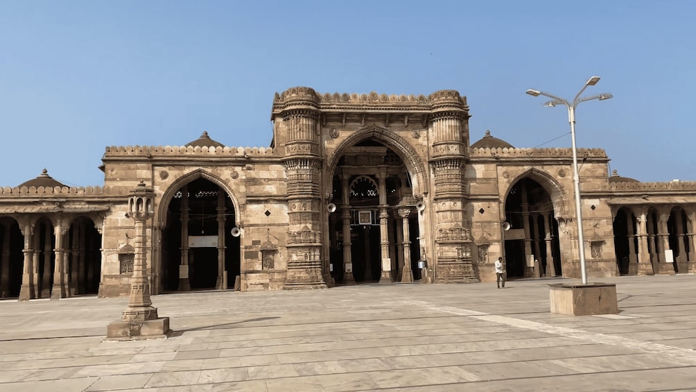 A historic building with intricate carvings and multiple arches. 1