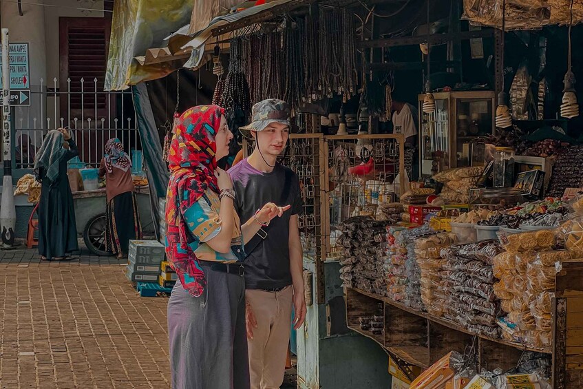 A street market with various goods displayed in stalls. 5