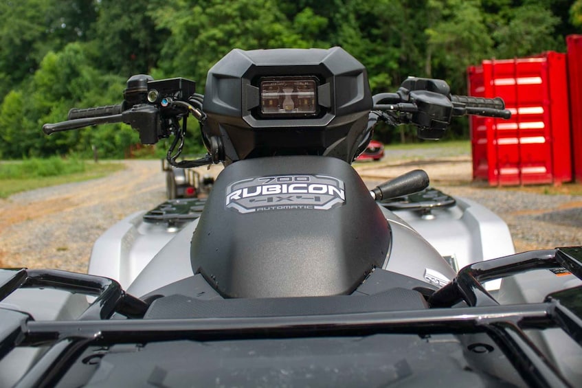 A Rubicon ATV with a black and grey color scheme, a mounted headlight, and a logo on the front. 2