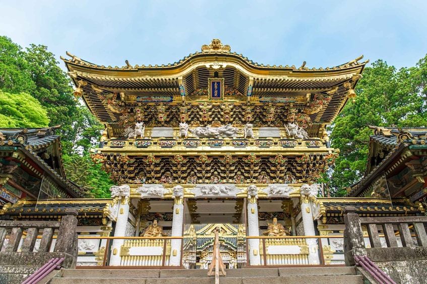 A traditional temple with ornate golden roofs and statues. 1