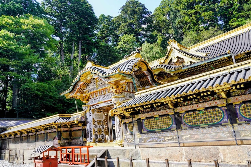 A traditional Japanese temple with ornate golden roofs and intricate designs. 4