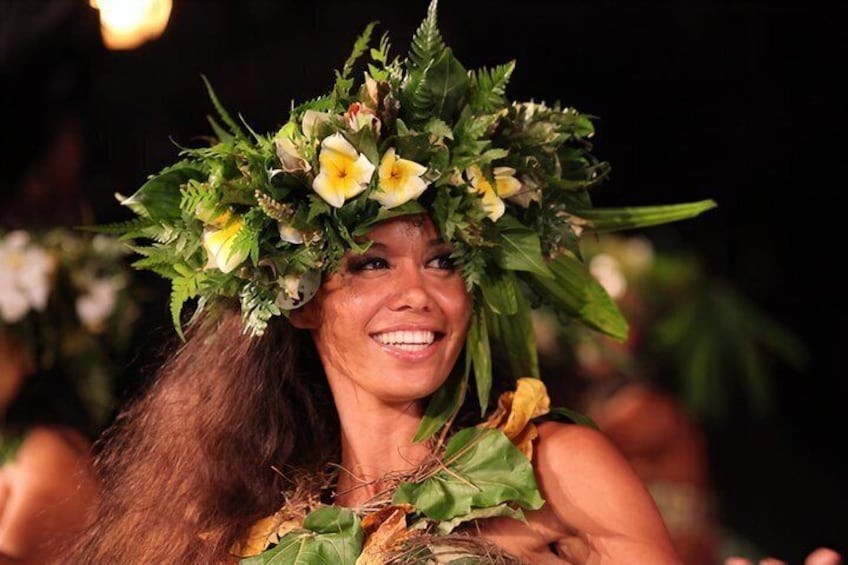 A person wearing a floral headpiece and a green garment. 4