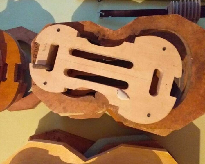 A wooden sculpture with abstract shapes and a circular cutout. 5