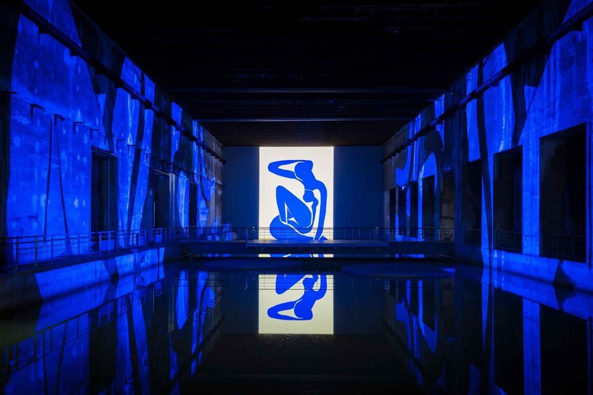 A dimly lit corridor with blue lighting and a large white silhouette of a figure. 1