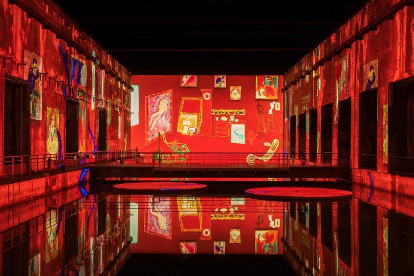 A theater with red lighting and a reflective floor. 5