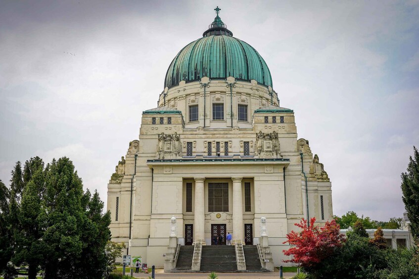 A large, historic building with a prominent dome and detailed facade. 3