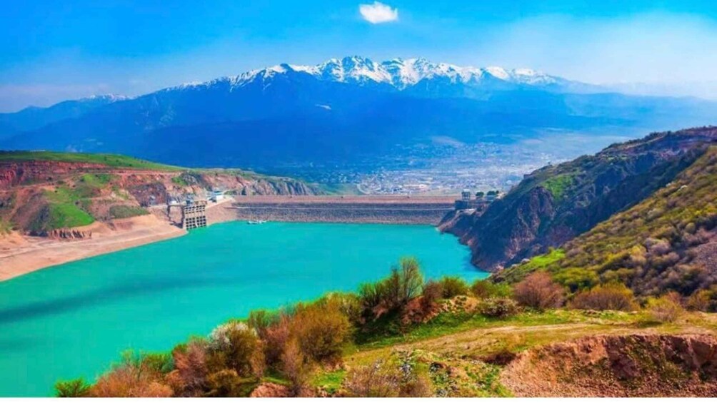 A mountainous landscape with a reservoir and a dam. 2