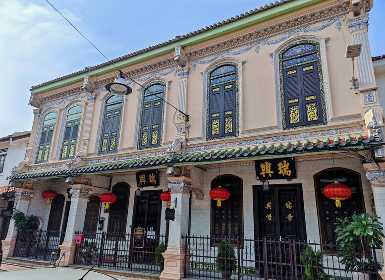 A traditional building with ornate decorations, large windows, and red lanterns. 5