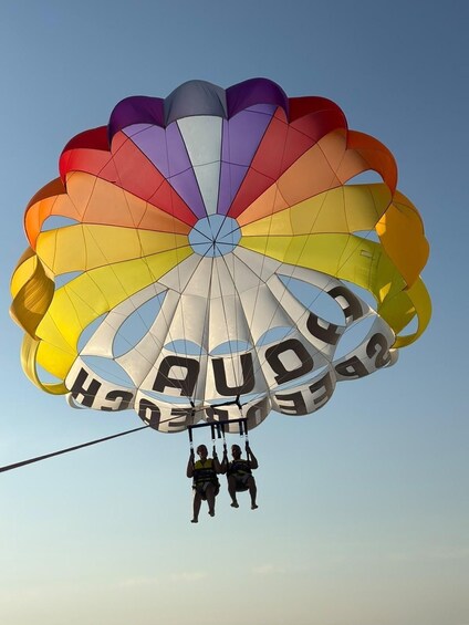 A person parachuting with a colorful parachute. 1