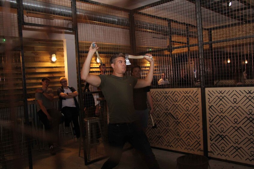 A person swinging a bat in a batting cage. 2