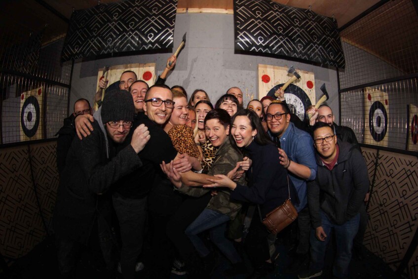 A group of people posing in a room with patterned walls and targets. 3