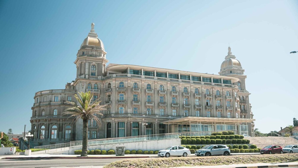 A large, historic building with two prominent domes and a central tower. 5
