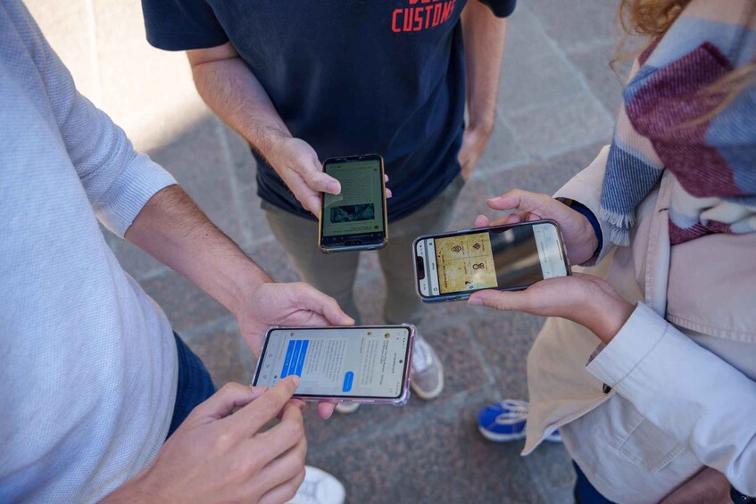 Four people holding smartphones, one of which displays a map. 5