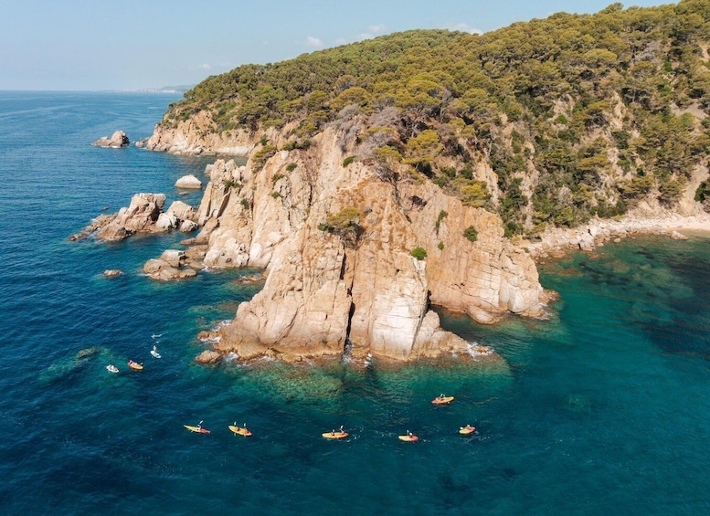 A coastal landscape with rocky cliffs and clear blue waters. 4