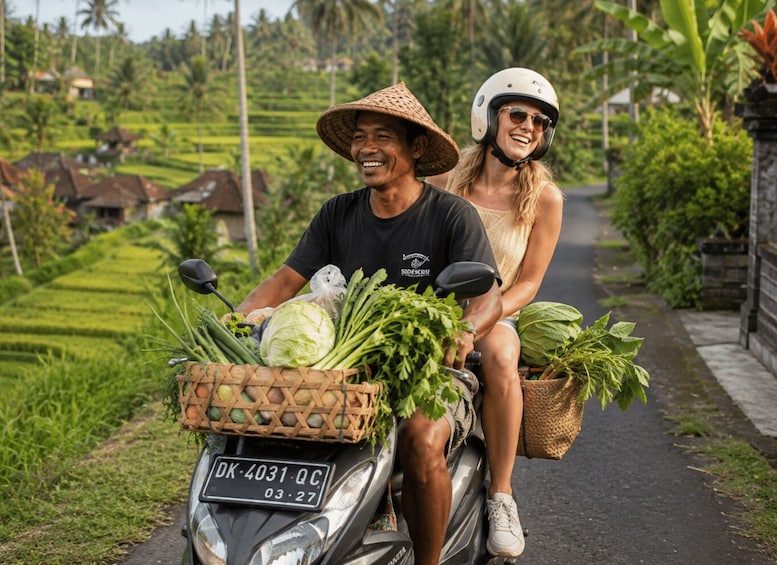 A person on a motorcycle with a basket of vegetables, another person beside them, and a rural landscape with houses and greenery. 1