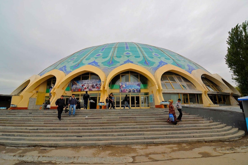 A large, domed building with colorful patterns on the roof and multiple arches. 2