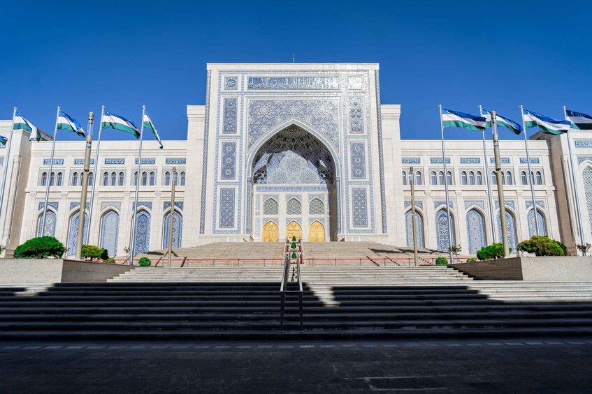 A grand building with intricate blue tile work and a large archway. 5