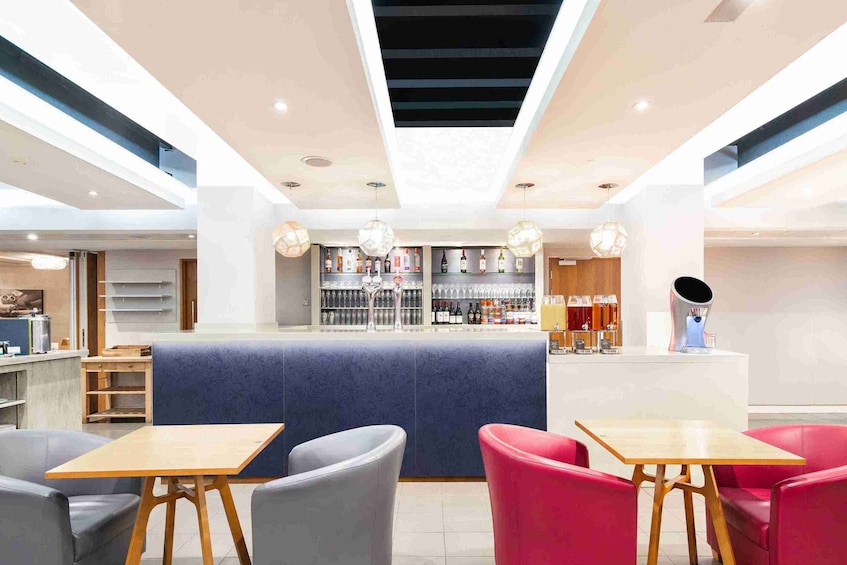 A modern bar area with seating and a counter. 4