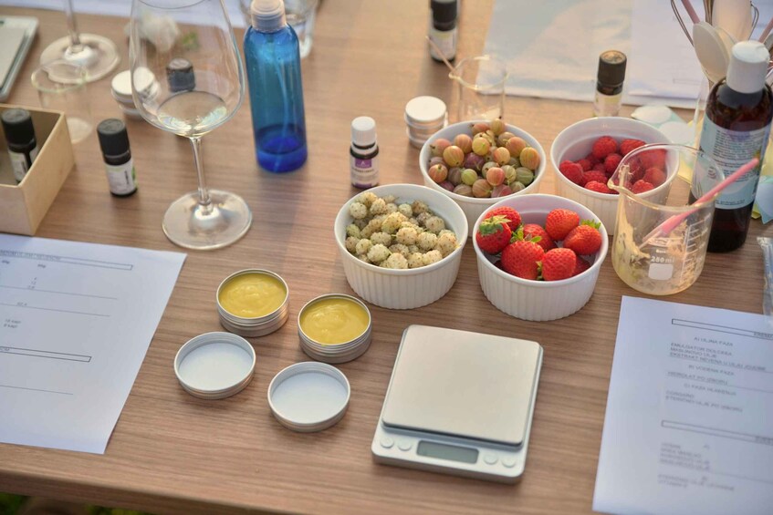 A table with various food items, a scale, and some bottles. 2