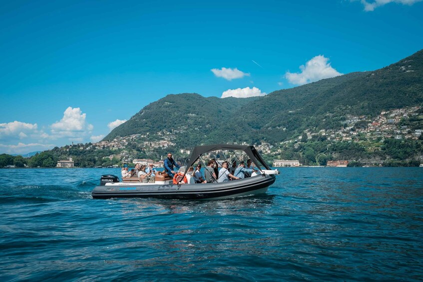A boat with passengers on a lake surrounded by hills. 2