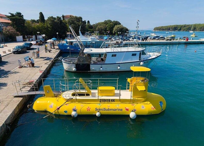 A marina with boats docked, a yellow inflatable boat, and a clear blue sky. 5