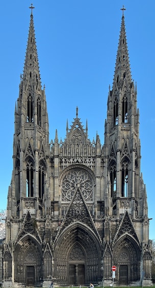 A Gothic cathedral with twin spires, intricate facade, and large rose window. 2