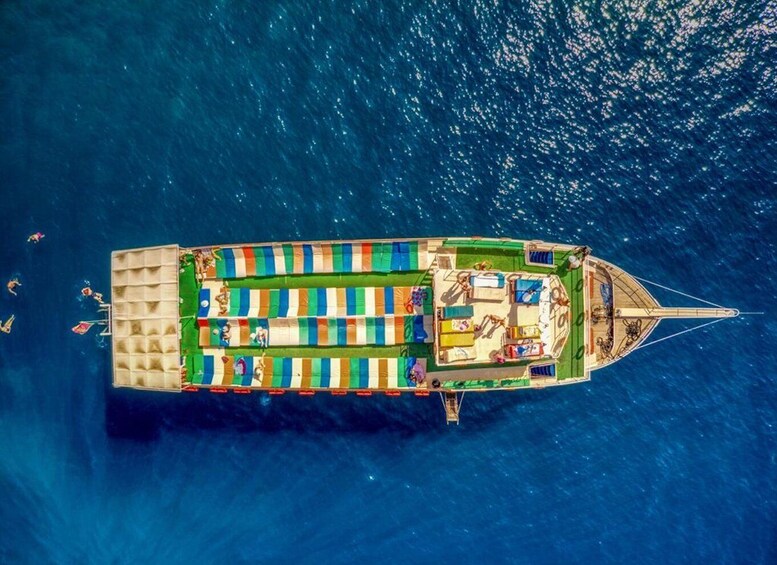 A boat with a striped deck and a small cabin at the stern. 2