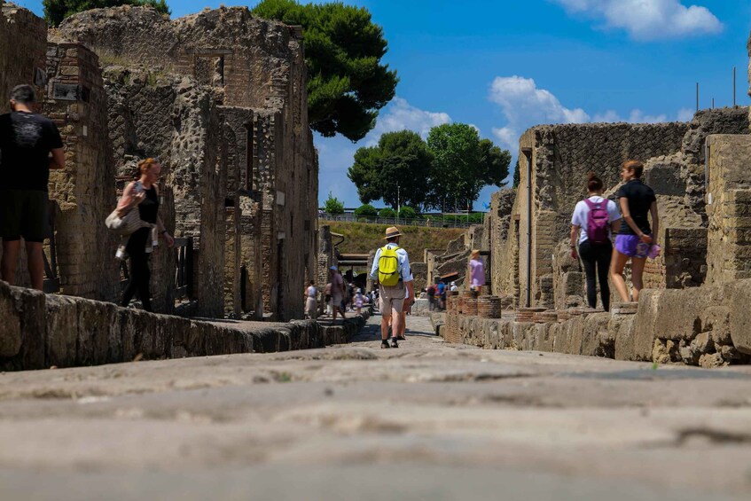Ancient ruins with visitors walking through the site. 1